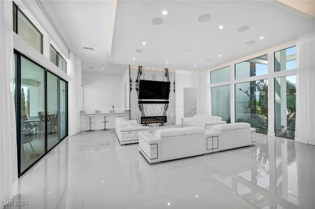 living room featuring expansive windows, a fireplace, and recessed lighting