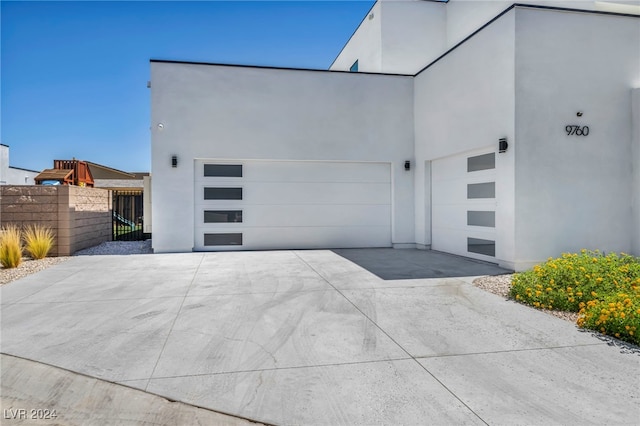 garage with driveway and fence