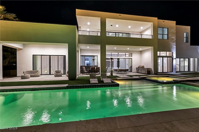 view of swimming pool featuring a patio area and a pool with connected hot tub