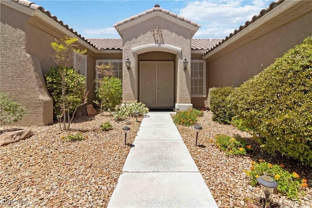 1629 Black Fox Canyon Rd, Henderson, NV 89052 - view of exterior entry with a tiled roof and stucco siding