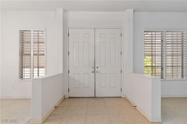 1629 Black Fox Canyon Rd, Henderson, NV 89052 - foyer with healthy amount of natural light, light tile patterned floors, and baseboards