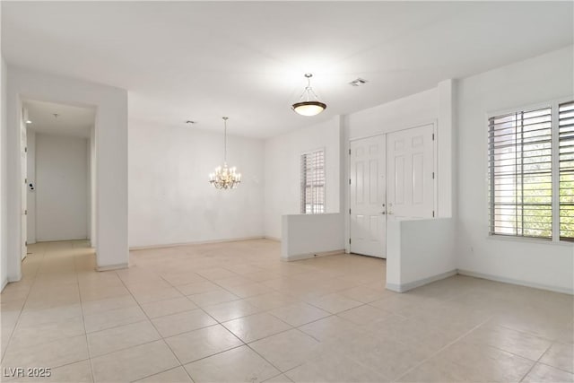 1629 Black Fox Canyon Rd, Henderson, NV 89052 - spare room featuring a chandelier, light tile patterned flooring, and baseboards