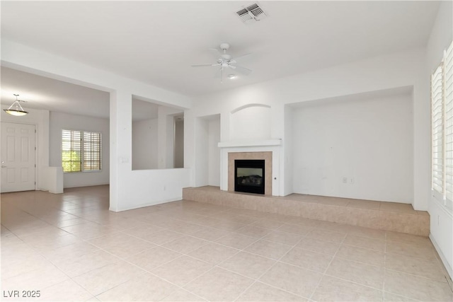 1629 Black Fox Canyon Rd, Henderson, NV 89052 - unfurnished living room featuring light tile patterned floors, ceiling fan, and a fireplace with raised hearth