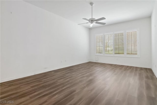 1629 Black Fox Canyon Rd, Henderson, NV 89052 - spare room featuring dark wood finished floors, a ceiling fan, and baseboards