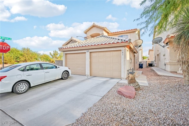 view of front of house featuring central AC and a garage