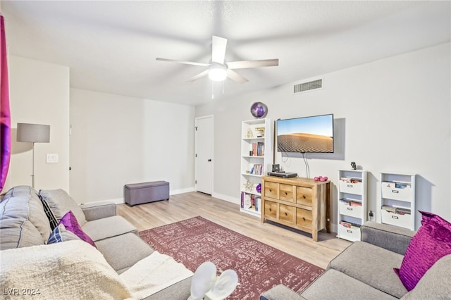 living room featuring ceiling fan and light hardwood / wood-style floors