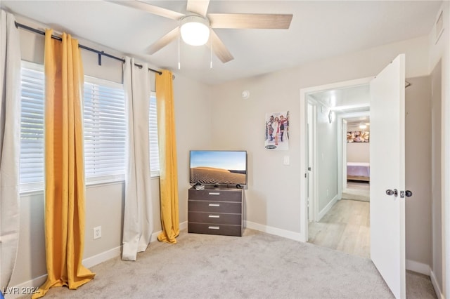 bedroom featuring ceiling fan and light colored carpet