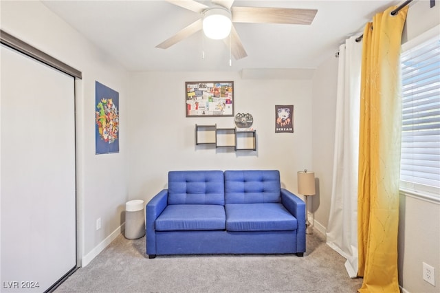 sitting room featuring ceiling fan, carpet floors, and a healthy amount of sunlight