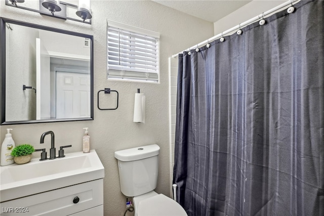 bathroom featuring vanity, toilet, and a shower with shower curtain