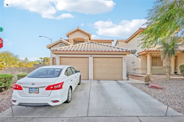 mediterranean / spanish-style home featuring a garage