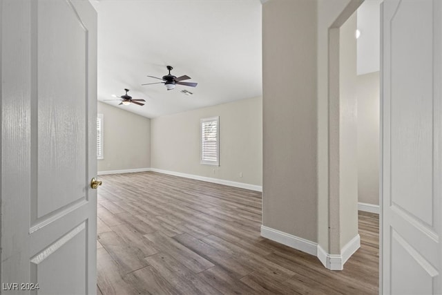 spare room with ceiling fan and light wood-type flooring