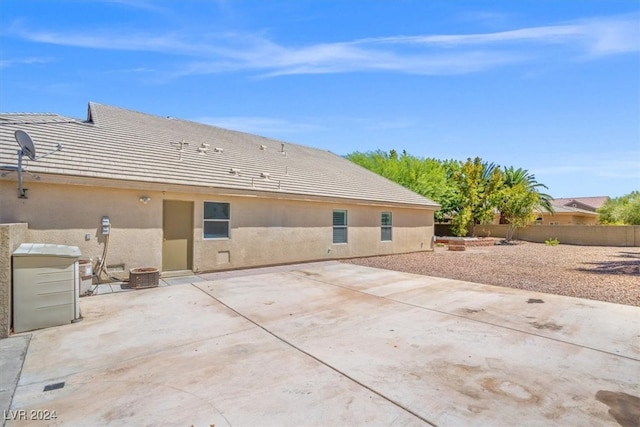 rear view of property with a patio and central AC unit