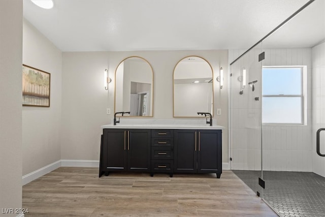 bathroom with vanity, hardwood / wood-style flooring, and a shower with door