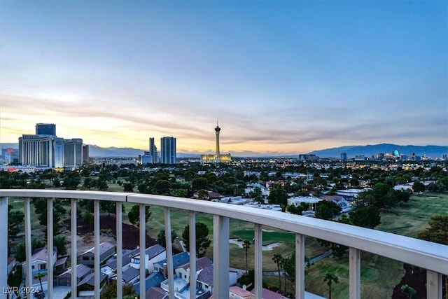 balcony at dusk with a view of city and a mountain view