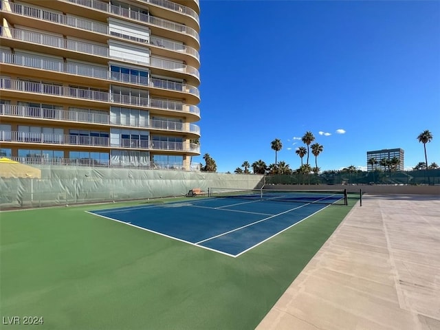 view of tennis court featuring fence