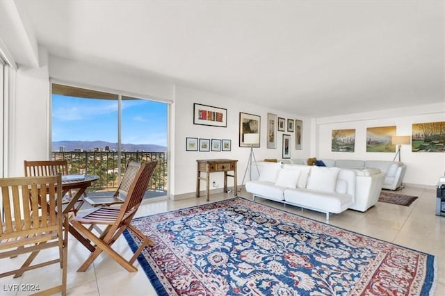 tiled living area featuring baseboards and a mountain view