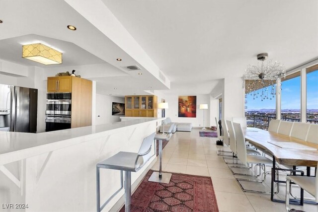 kitchen featuring light tile patterned flooring and stainless steel appliances