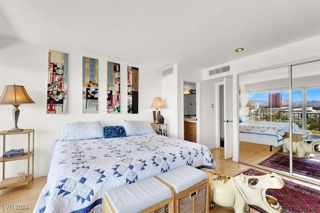 bedroom with wood finished floors and visible vents