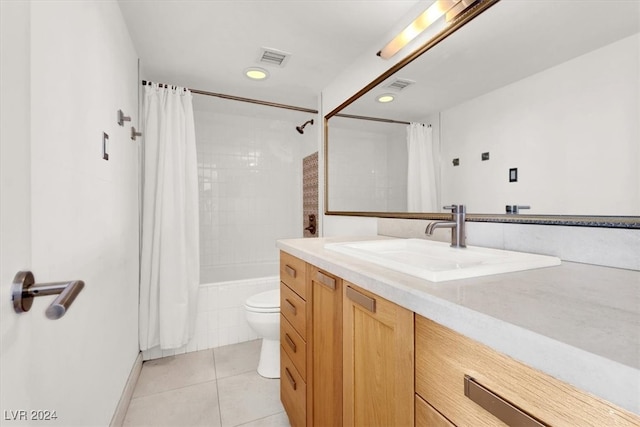 bathroom featuring toilet, vanity, and tile patterned floors