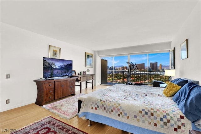 bedroom featuring access to outside and light hardwood / wood-style flooring