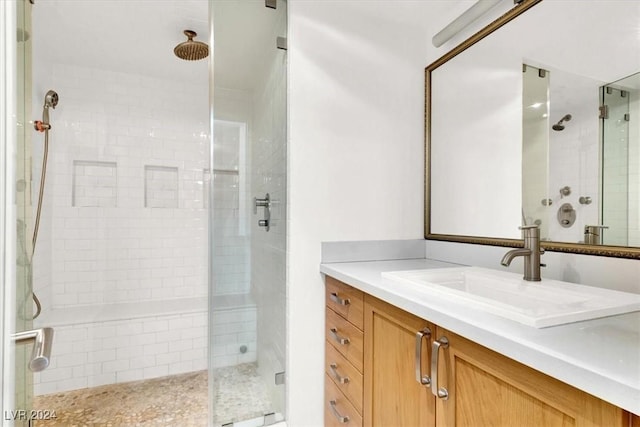 bathroom featuring a shower stall and vanity