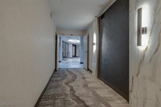 corridor featuring light tile patterned floors