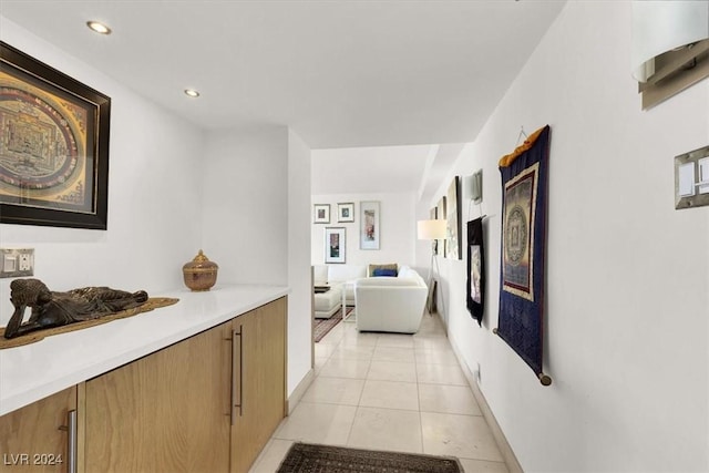 hallway with light tile patterned floors, baseboards, and recessed lighting