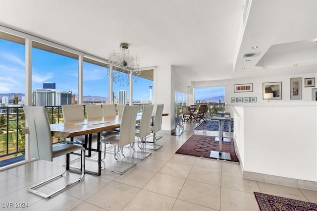 dining area featuring a wall of windows, a wealth of natural light, and a view of city