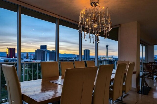 tiled dining room with a chandelier