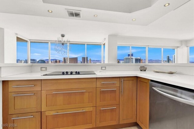 kitchen featuring black electric cooktop, a chandelier, and dishwasher