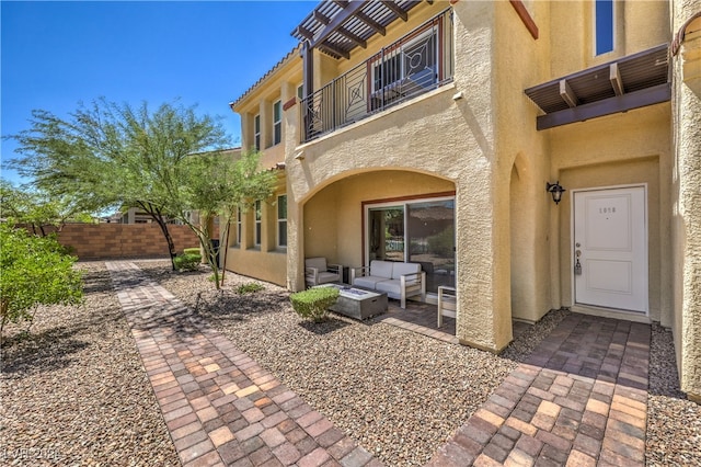 rear view of property with a patio, outdoor lounge area, and a balcony