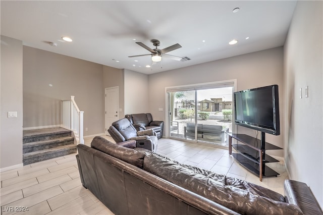 tiled living room with ceiling fan