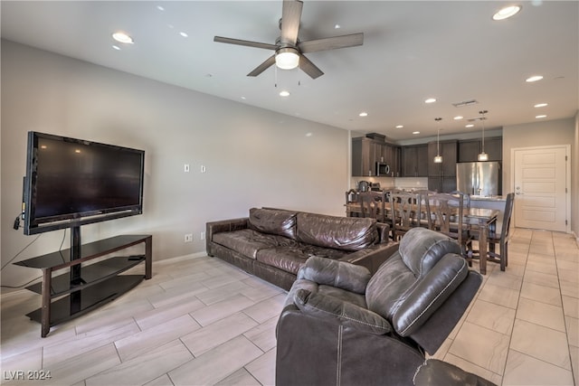 living room with ceiling fan and light tile patterned floors