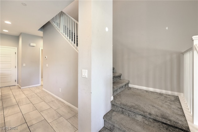 staircase with tile patterned flooring