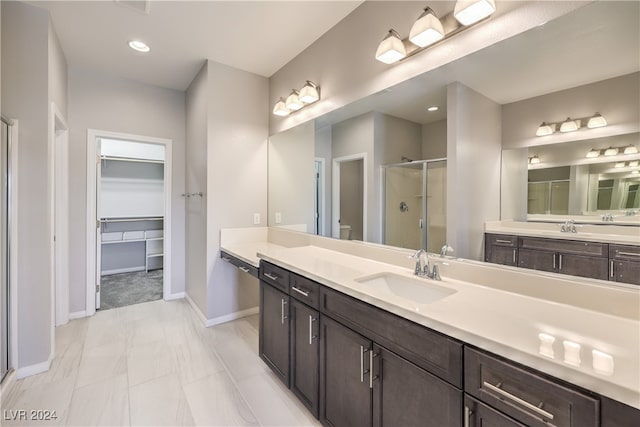 bathroom with an enclosed shower, toilet, vanity, and tile patterned floors