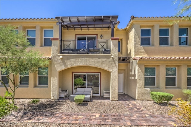 back of property with a patio and a balcony