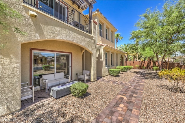 exterior space with a patio area, an outdoor living space, and a balcony