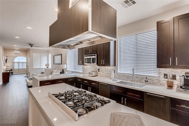 kitchen featuring visible vents, open floor plan, stainless steel appliances, light countertops, and a sink