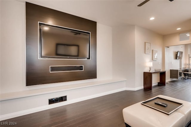 unfurnished living room featuring dark wood-type flooring, recessed lighting, baseboards, and a ceiling fan