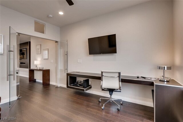 home office featuring built in desk and dark hardwood / wood-style floors