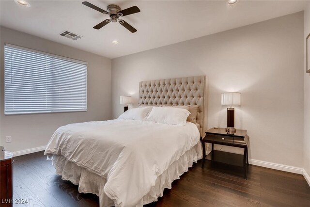 bedroom with ceiling fan and dark hardwood / wood-style flooring