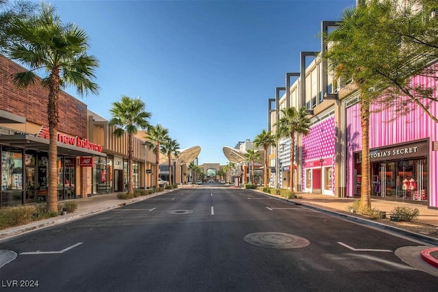 view of street featuring curbs, sidewalks, and street lights