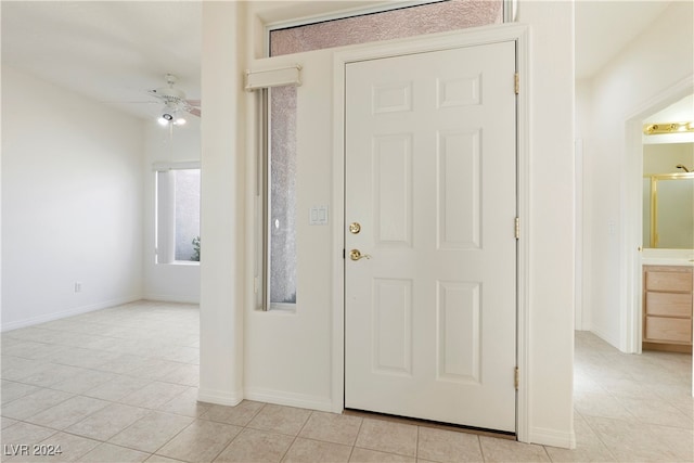 entryway with light tile patterned floors and ceiling fan