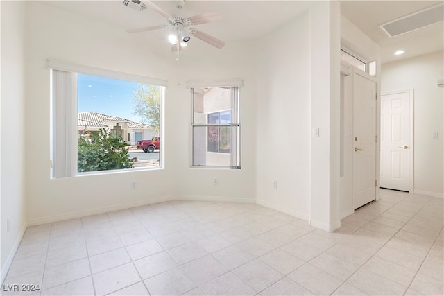 empty room featuring ceiling fan and light tile patterned floors