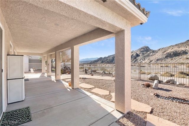 view of patio / terrace featuring a mountain view