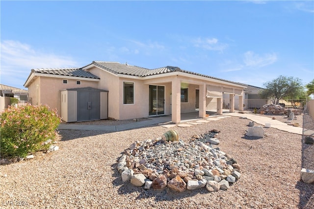 view of front of home with a patio and a storage shed