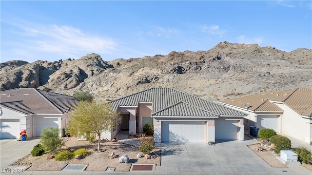 view of front of home with a garage and a mountain view