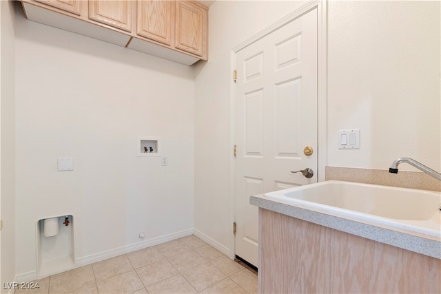 laundry room featuring sink, cabinets, hookup for a washing machine, and light tile patterned floors