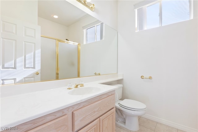 bathroom with tile patterned flooring, vanity, walk in shower, and toilet