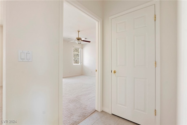 hallway featuring light colored carpet